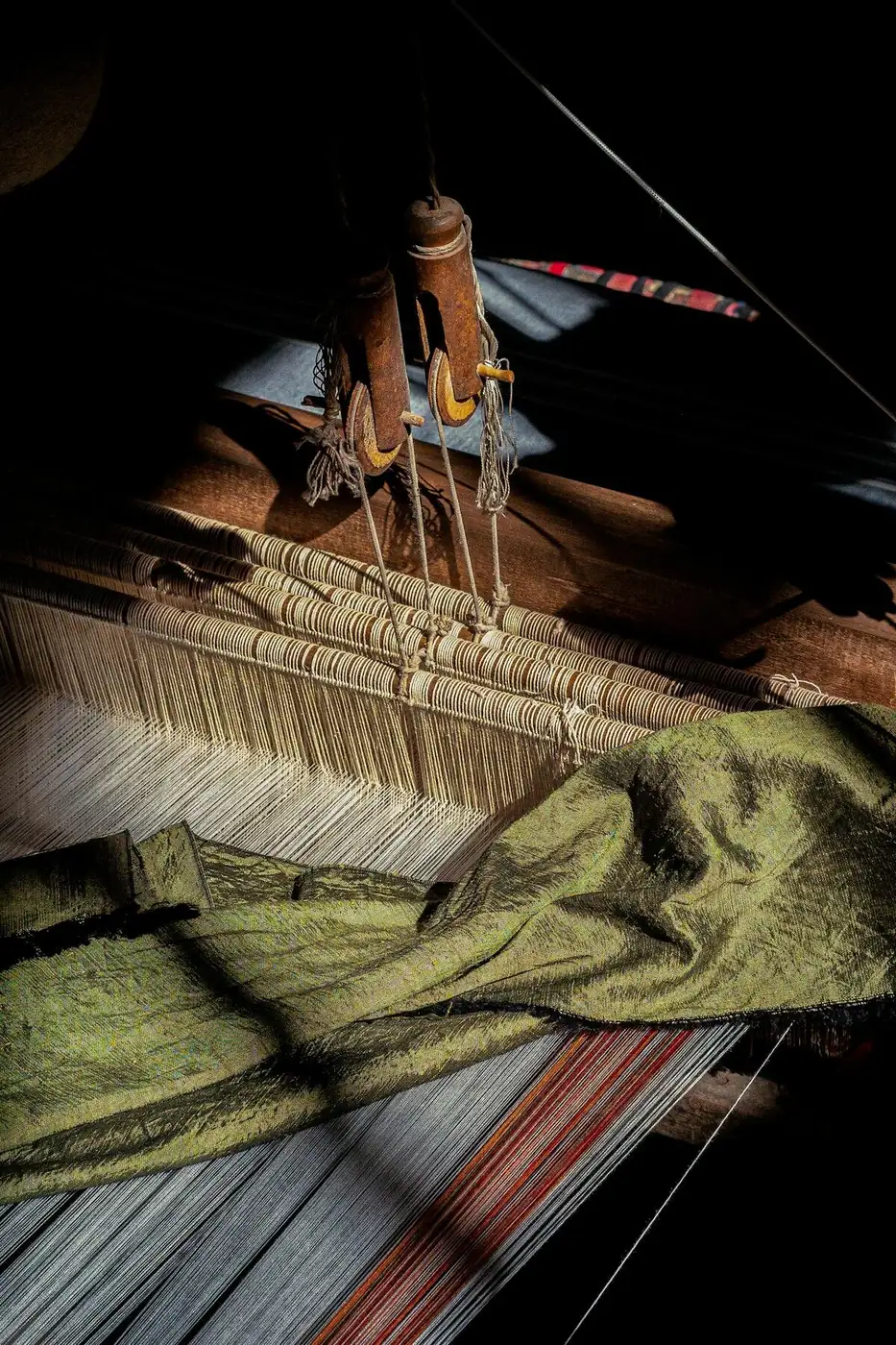 Close detail of a traditional loom mid-weave.